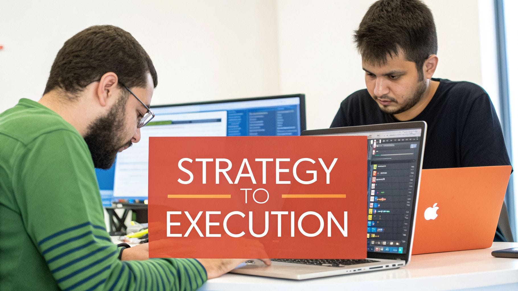 Two young men focus on their laptops at a shared workspace. A prominent graphic in the foreground reads "STRATEGY TO EXECUTION" in bold lettering.